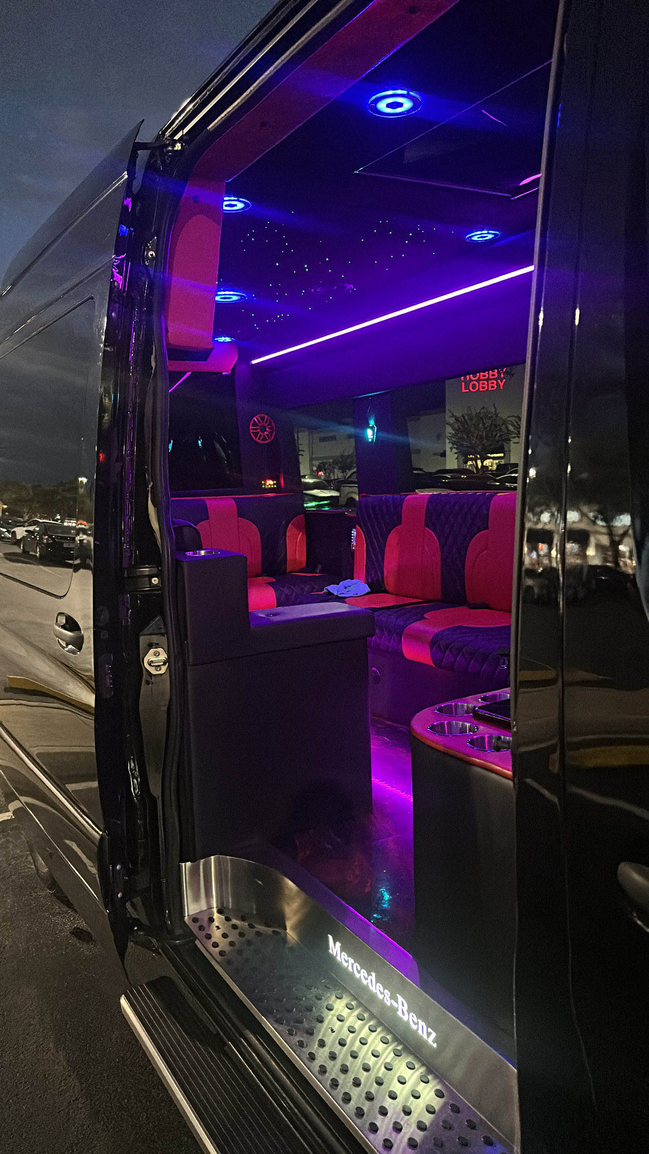 Sprinter party bus interior with LED ambient lighting and starlight ceiling